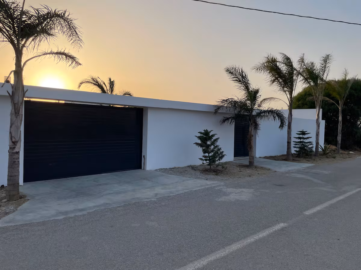 Villa exterior with palm trees at sunset in Tangier